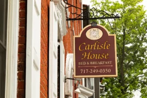 Remodel new photo of sign on the outside of the Carlisle House saying "Carlisle House Bed & Breakfast 717-249-0350"