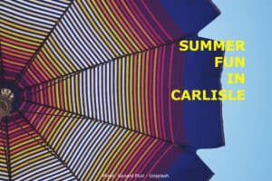 A view from under a brightly colored patio table umbrella with title: Summer Fun In Carlisle.