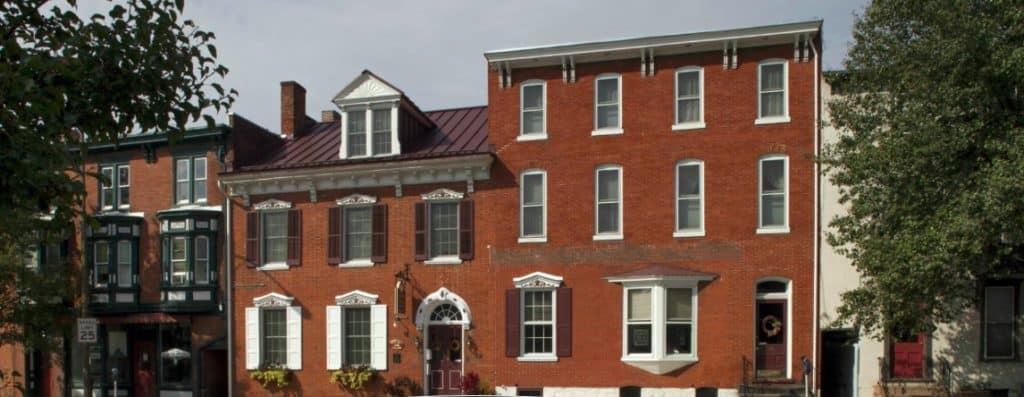 A photo of the red brick, two-story inn.